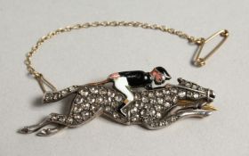 A GOLD DIAMOND SET AND ENAMEL HORSE RACING BROOCH