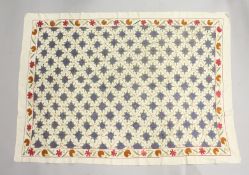 AN ISLAMIC EMBROIDERED TEXTILE, possibly Persian / Susani, cream ground with all over flower head