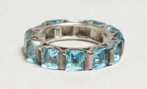 A SILVER BLUE TOPAZ ETERNITY RING
