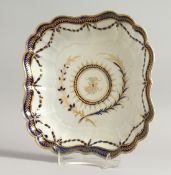 A WORCESTER SQUARE PORCELAIN DISH with blue and gilt border. Crescent mark in blue 9ins high.