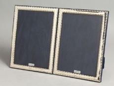 A LARGE PAIR OF SILVER PHOTOGRAPH FRAMES. 19cm x 14cm.