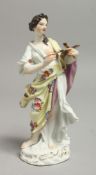 AN 18TH CENTURY MEISSEN FIGURE OF A FEMALE ARTIST with paint brushes and artist palette, wearing a