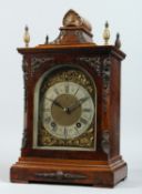 A GEORGE III DESIGN WALNUT CASED BRACKET CLOCK, with an eight day movement striking on a gong, brass