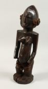 A GOOD CARVED WOOD YORUBO FEMALE STANDING FIGURE. 18ins.
