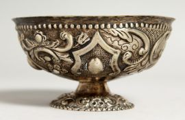 A CONTINENTAL SILVER EMBOSSED CIRCULAR PEDESTAL BOWL.
