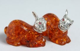 A PAIR OF FAUX AMBER RABBITS