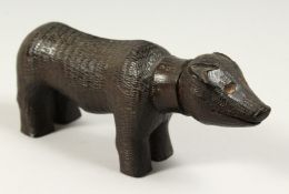 A RARE NAIVE LIGNUM VITAE PIG 7.5ins long.