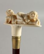 A WALKING STICK with carved bone handle 'Erotic'. 36ins long.