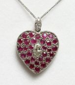 A RUBY AND DIAMOND HEART SHAPED PENDANT AND CHAIN.