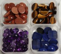 FOUR SMALL BOXES OF CABOCHON STONES