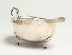 A SAUCEBOAT with waved rim, on three pad feet. Birmingham.