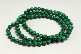 A MALACHITE STRING OF BEADS