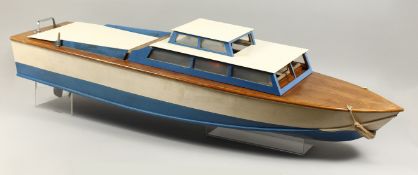 A LARGE MODEL CABIN CRUISER, cream and blue, with engine. 44ins long.