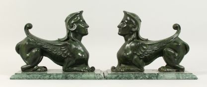 A GOOD PAIR OF BRONZE GRIFFINS on marble bases. 10ins high