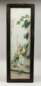 A CHINESE FRAMED UPRIGHT PORCELAIN PLAQUE. 29ins high, 8ins wide.