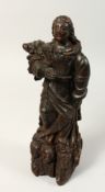 A 17TH CENTURY CARVED WALNUT FIGURE OF A SAINT, possibly Italian. 14ins high.