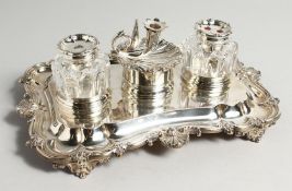 A SUPERB WILLIAM IV SILVER INKWELL with two silver glass bottles and a shell shaped chamber stick.