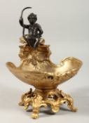 A GOOD GILT BRONZE SALT with a bronze cupid. 7ins high.