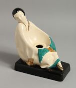 C. H. FRANCE CHARLES HARVA. FRENCH ART POTTERY FIGURE. A SEATED FIGURE OF A YOUNG LADY on a black
