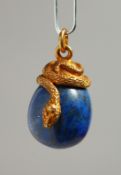 A RUSSIAN SILVER AND LAPIS EGG PENDANT with entwined snake