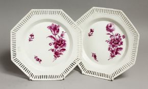 A PAIR OF BERLIN PORCELAIN OCTAGONAL PLATES with pierced borders with flowers in puce. Sceptre