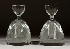 A PAIR OF CUT GLASS ROUND SCENT BOTTLES AND STOPPERS. 5.5ins high.