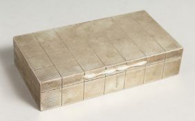 AN ENGINE TURNED RECTANGULAR CIGARETTE BOX with cedarwood linger. 6.5ins long, Birmingham, 1938.