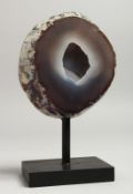 A GEODE 4.5ins, on a wooden base.