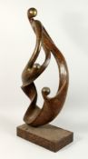 A LARGE ABSTRACT BRONZE, ENTWINED FIGURES on a rectangular base. 34ins high.