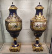 A SUPERB LARGE PAIR OF 19TH CENTURY SEVRES PORCELAIN URNS AND COVERS, rich blue ground with gilt