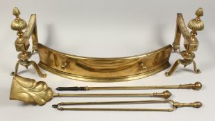 A PAIR OF VICTORIAN BRASS FIRE DOGS, together with three brass fireside tools and s small fender