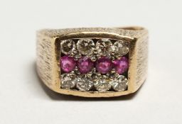 A 9CT GOLD THREE ROW DIAMOND AND RUBY RING