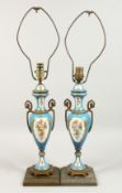 A PAIR OF SEVRES DESIGN PORCELAIN TWO HANDLED VASES converted to lamps. 19ins high.