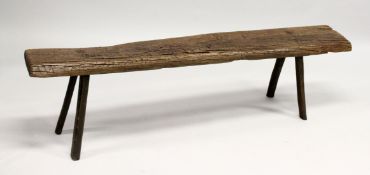 AN EARLY RUSTIC OAK BENCH SEAT on four legs. 5ft 2ins long x 1ft 4ins high.