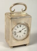 A MINIATURE SILVER CASED CLOCK in a plain case with carrying handles and ball feet. 3.5ins high,