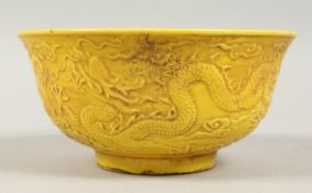 A CHINESE YELLOW GROUND BOWL decorated with dragons. 6ins diameter.