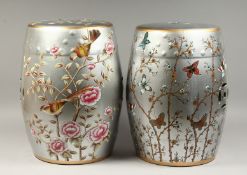 A PAIR OF CHINESE SILVER POTTERY BARREL SEATS painted with birds and flowers. 17ins high.