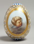 A GOOD PORCELAIN EGG, POSSIBLY RUSSIAN, painted with a cupid's head. 9cm long.