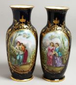 A GOOD PAIR OF SEVRES DARK BLUE PORCELAIN VASES edged in gilt and painted with young ladies. 15ins