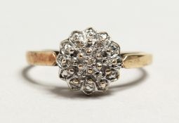 A 9CT GOLD DIAMOND CLUSTER RING.
