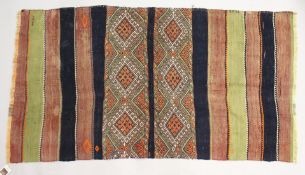 A PERSIAN KELIM RUG, with a pair of geometric bands to the centre, alternating bands of black, red