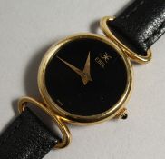 A LADIES 18CT GOLD EBEL WRISTWATCH with leather strap in an original leather pouch.