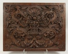 A GOOD OAK PANEL 18TH CENTURY carved with urn, birds, wolf, and coat. 18ins x 23ins.