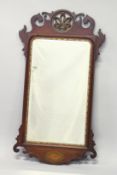 A GEORGE III MAHOGANY FRET WORK FRAMED MIRROR with carved and gilded Prince of Wales feathers