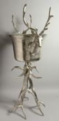 A LARGE SILVER-PLATED STAG WINE COOLER on a plated antler stand. 41ins high.