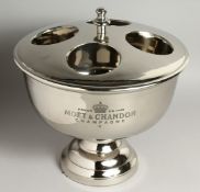 A SILVER-PLATED MOET AND CHANDON CIRCULAR FOUR BOTTLE WINE COOLER AND COVER. 14ins high.