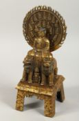 A GILT BRONZE FIGURE sitting on a horse, with two lions. 11ins high