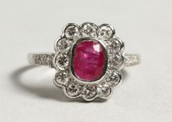 AN 18CT WHITE GOLD RUBY AND DIAMOND CLUSTER RING.