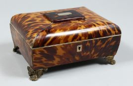 A GOOD TORTOISESHELL SEWING BOX with fitted interior, mirror in the lid, on claw feet. 8.5ins high.