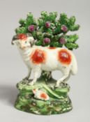 A STAFFORDSHIRE BOCAGE GROUP OF A RAM. 5.25ins high.